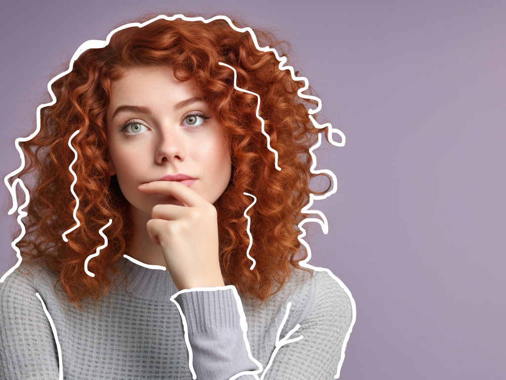 A woman, with her finger on her chin, appears thoughtful and concerned as she ponders the answer to the question, "Are perms bad for your hair?"