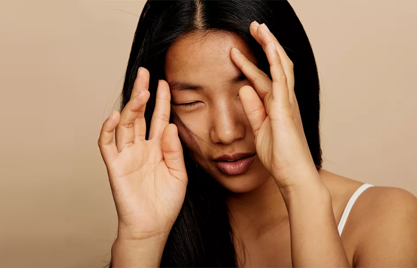 asian woman touching soft hair after using coconut oil for hair growth effects