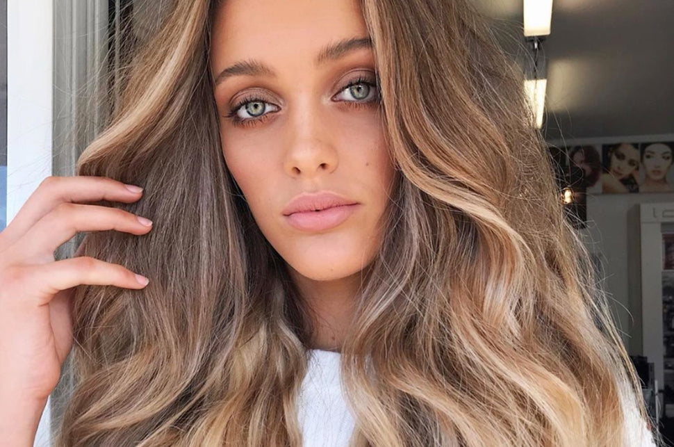 Girl wearing halo hair extensions on a Round Up Of The Best Hair Growth Products For Rapid Results