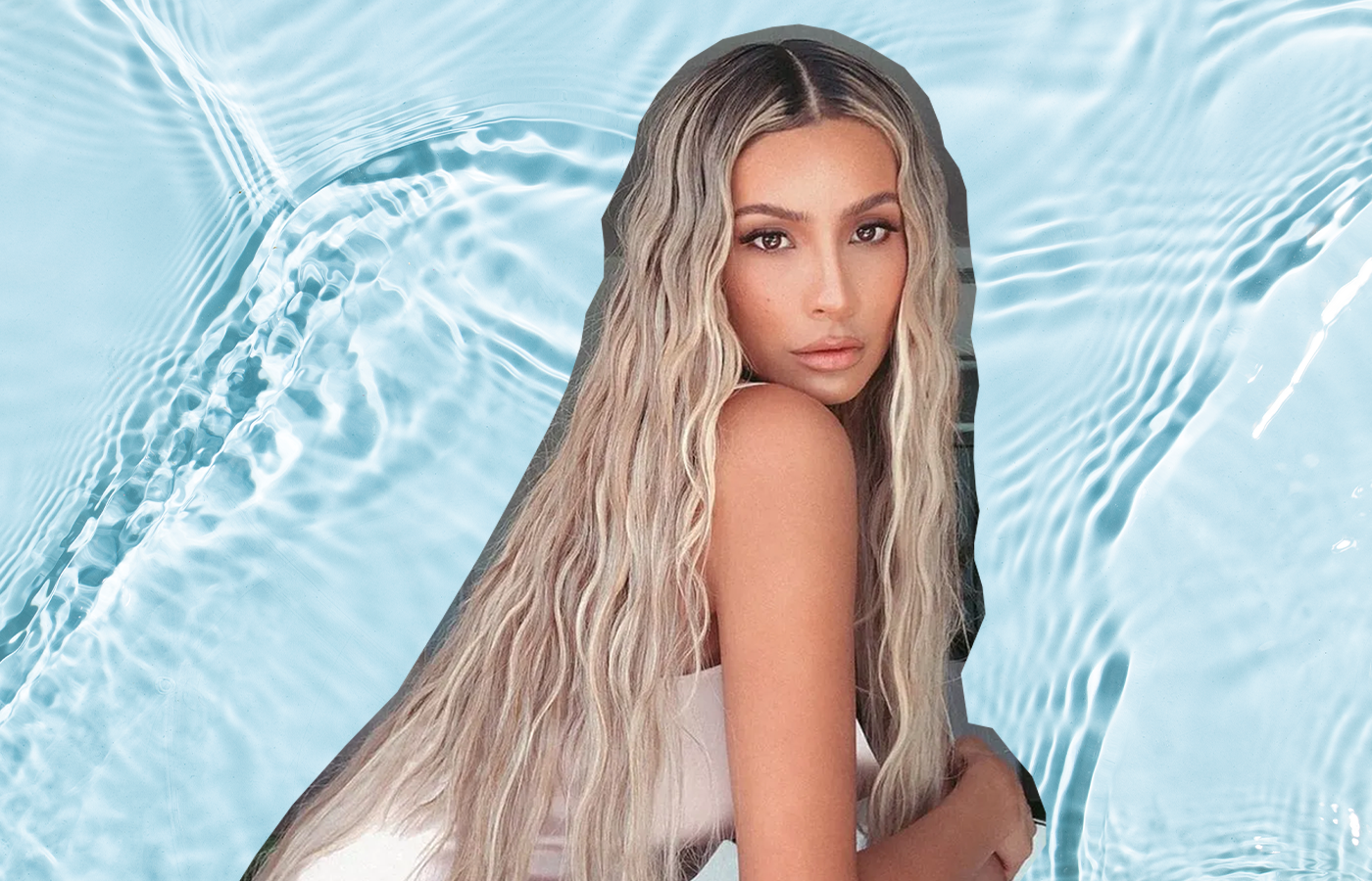 woman against blue wave background with mermaid wave hairstyle; she has blonde hair and is sitting facing profile