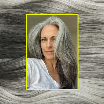 woman wearing grey hair extensions against grey hair macro image background