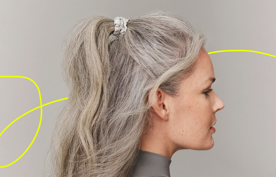 woman with grey hair wearing two hair scrunchies to protect her hair