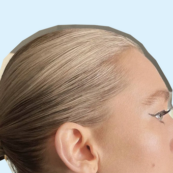 side profile of blonde woman with a Slick Back Bun Style done to her hair