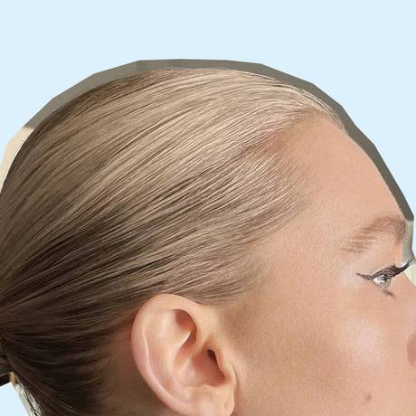 side profile of blonde woman with a Slick Back Bun Style done to her hair