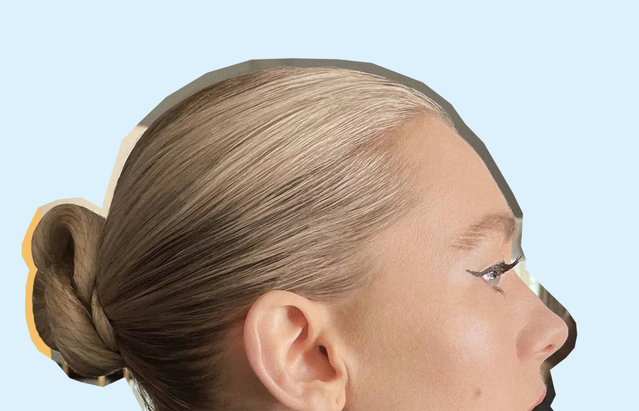 side profile of blonde woman with a Slick Back Bun Style done to her hair