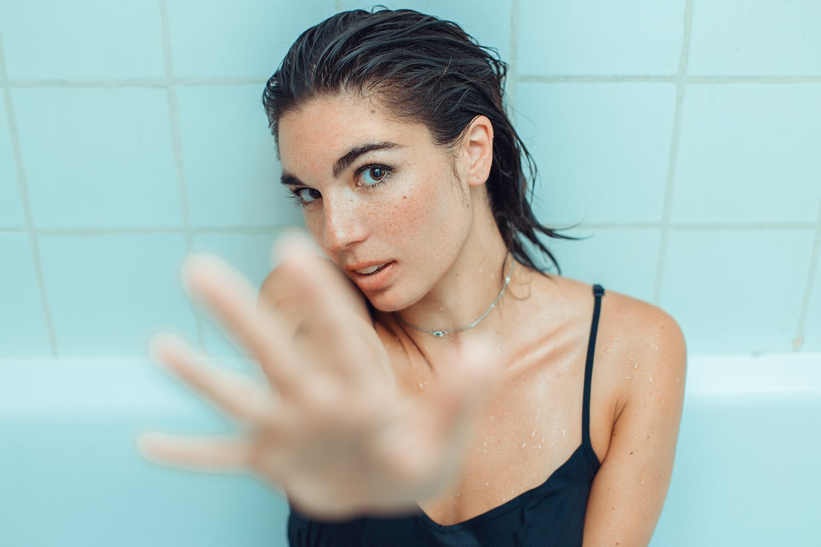 Woman spending time in the bath thinking how she can protect skin from hard water.