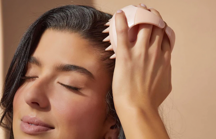 woman demonstrating how to do scalp massage for hair growth benefits