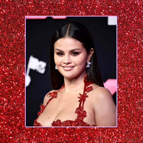 Selena Gomez's red carpet hair style shown as down and straight. She is wearing a red dress.