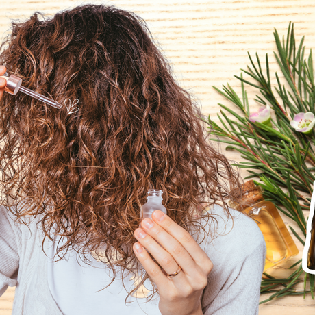 Discover the benefits of tea tree hair oil as a woman applies it to her flowing locks.