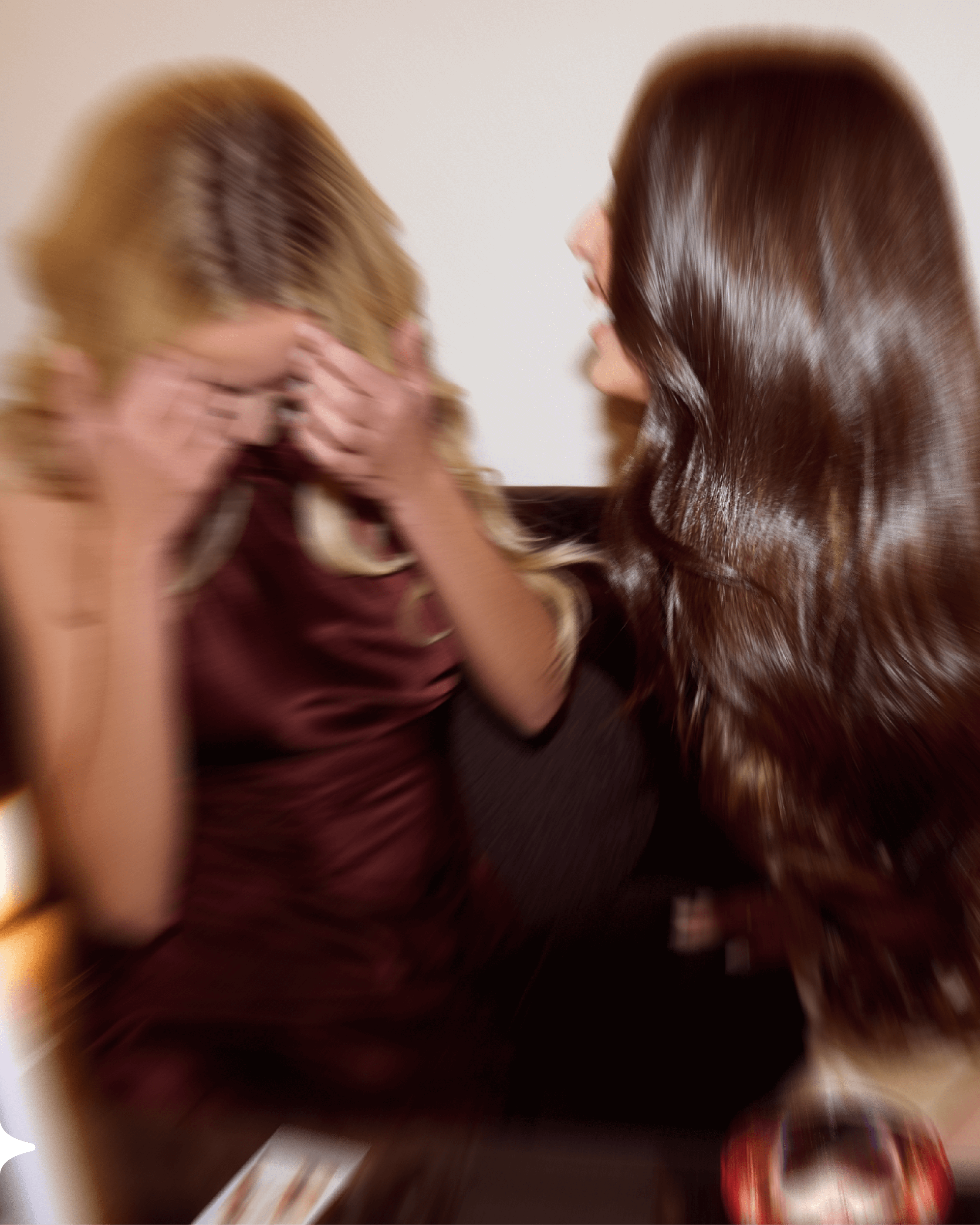 Two women in gowns wear their halo hair extensions while getting ready for a night out