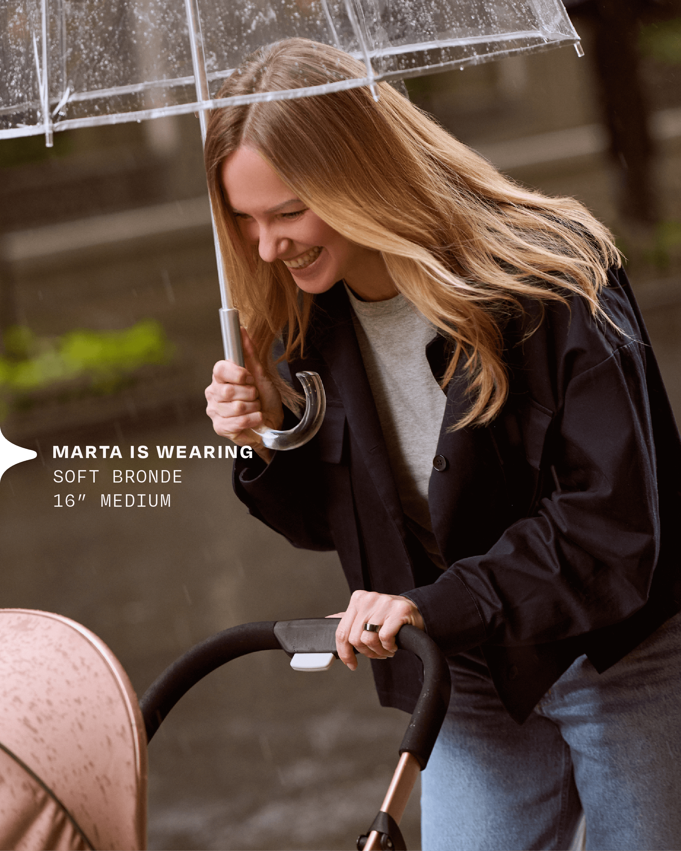 A mother wears her halo hair extension while out for a walk with her baby in a stroller