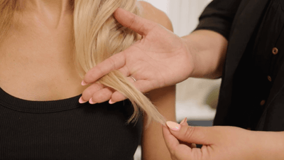 A professional hair stylist discussing when you should take your halo hair extension to a professional stylist