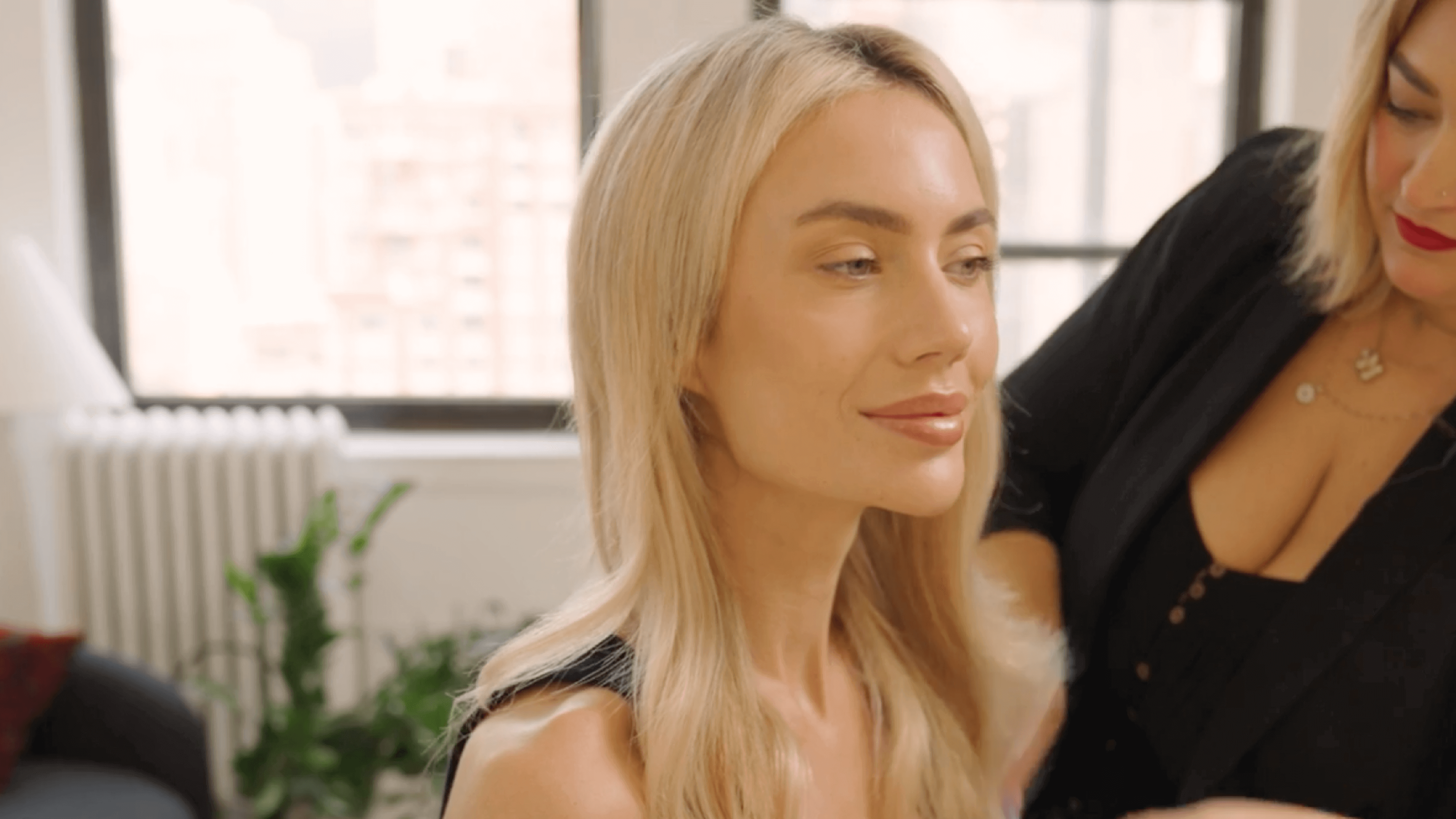 A professional hair stylist showing how to find your perfect halo hair extension color match